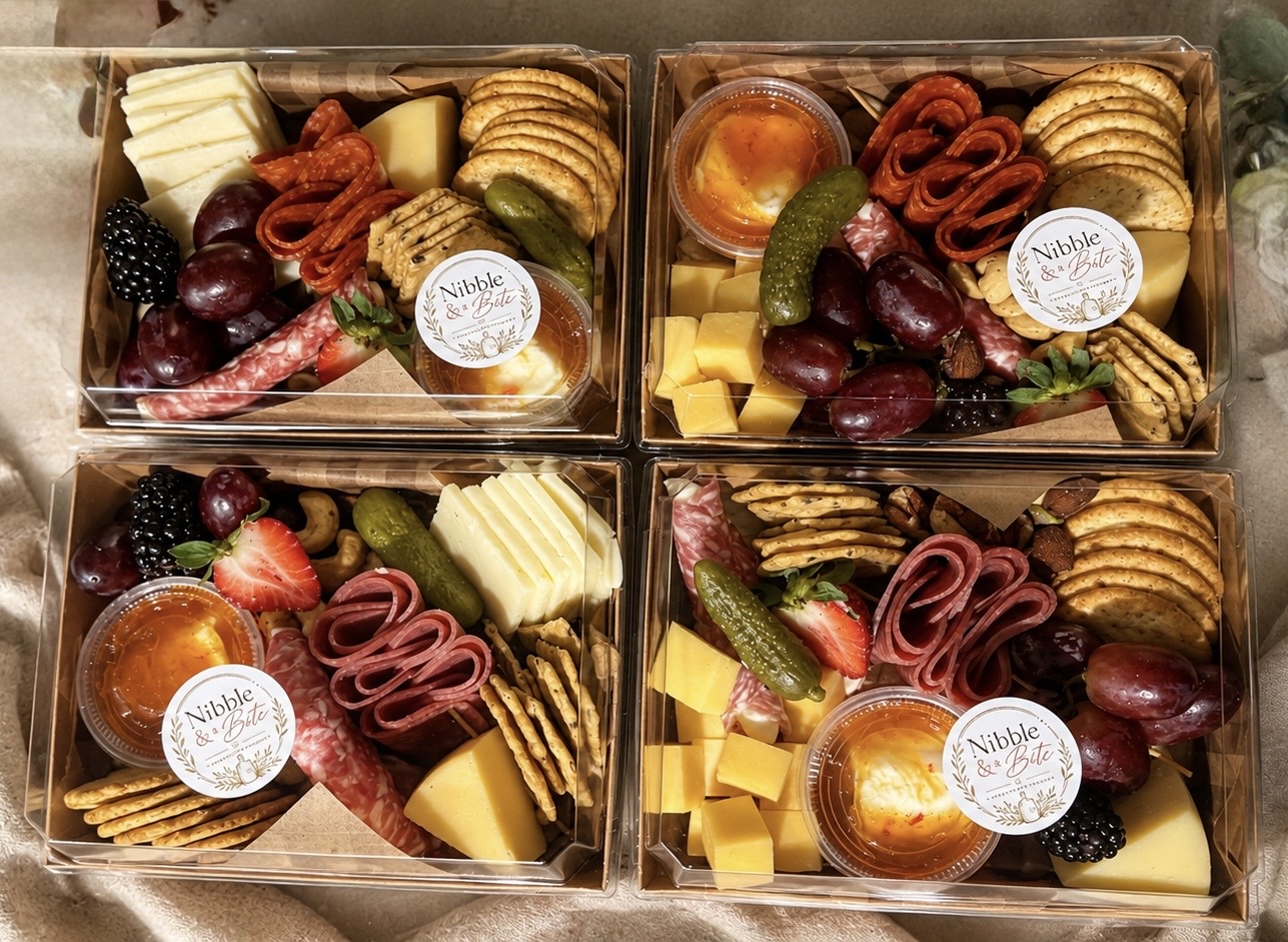 Four Nibble & a Bite branded charcuterie boxes