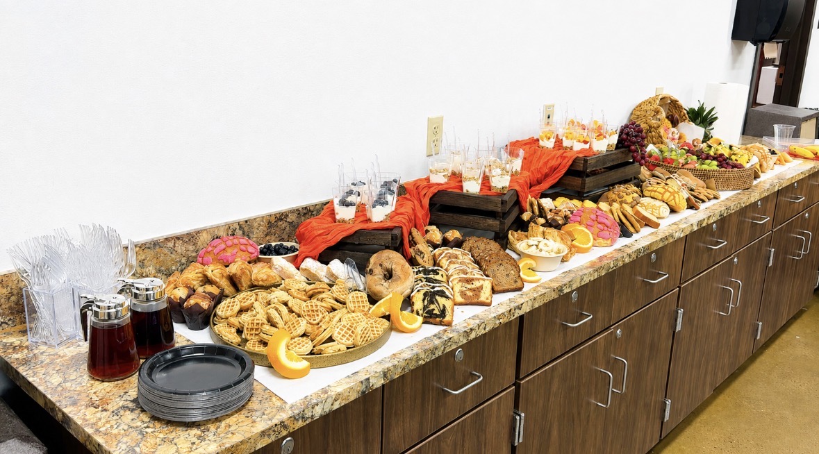 Large grazing table spread from a side angle at an event