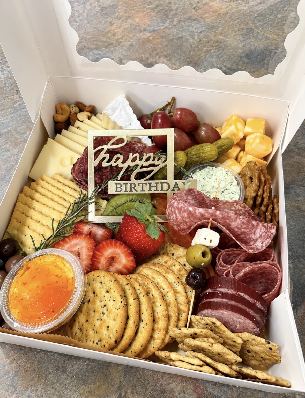 Birthday charcuterie box with a Happy Birthday sign
