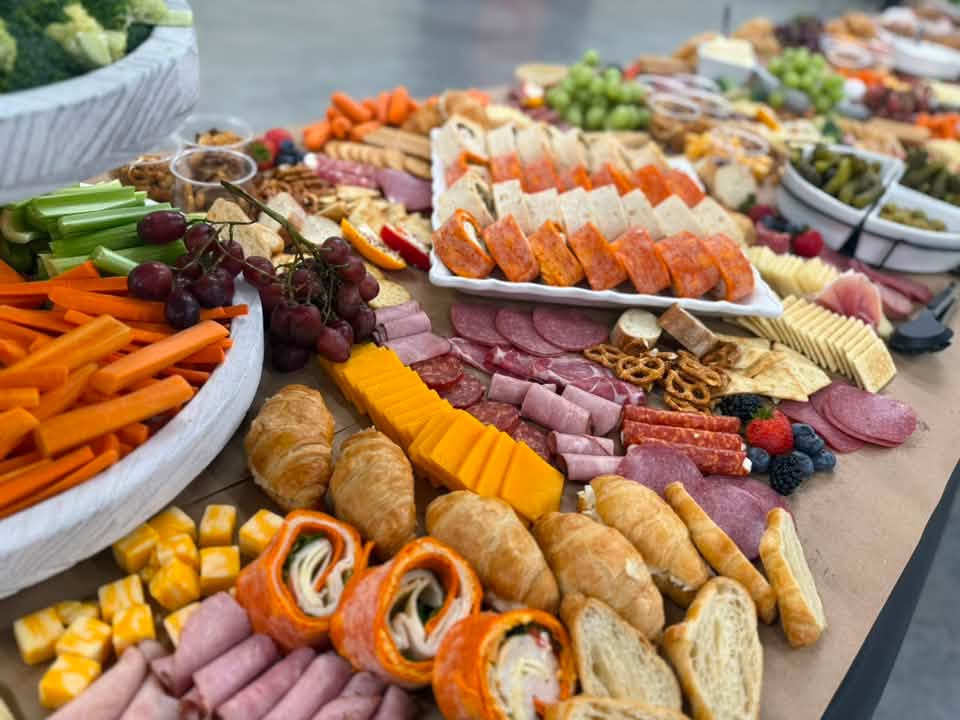 Close-up of a large grazing table with croissants and meats
